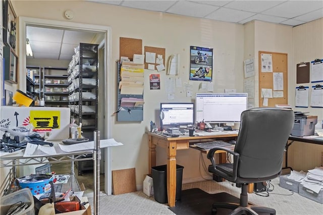 carpeted home office featuring a paneled ceiling