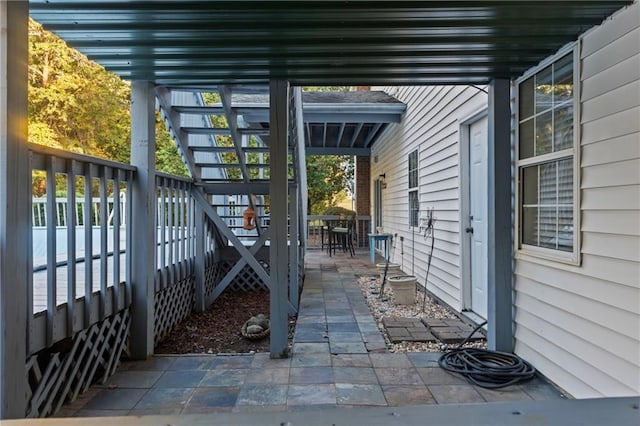 view of patio / terrace featuring outdoor dining area and stairs
