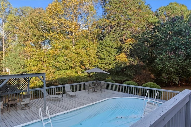 pool featuring a deck and outdoor dining space