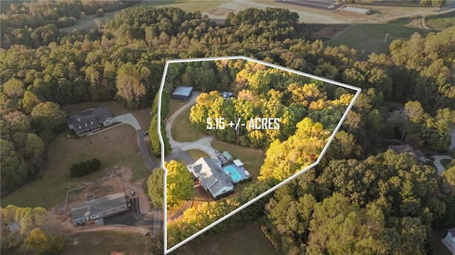 birds eye view of property with a wooded view