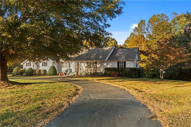 ranch-style house with a front lawn and driveway