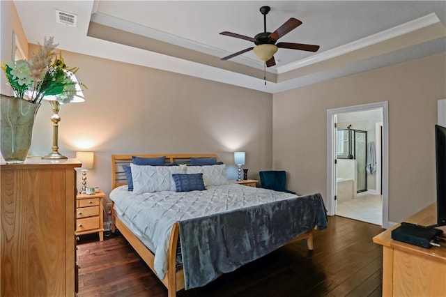 3920 Baverton Dr, Suwanee, GA 30024 - bedroom featuring a tray ceiling, dark wood-type flooring, crown molding, ensuite bathroom, and a ceiling fan