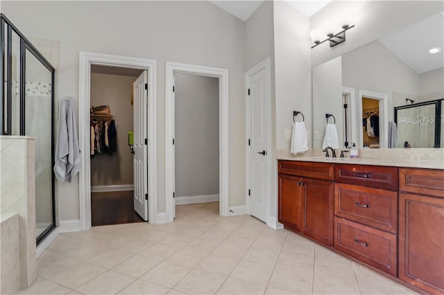 3920 Baverton Dr, Suwanee, GA 30024 - full bathroom featuring a stall shower, tile patterned floors, vanity, a spacious closet, and lofted ceiling