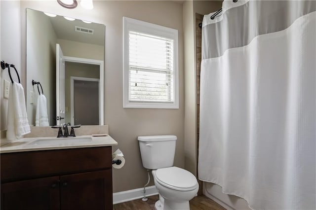 3920 Baverton Dr, Suwanee, GA 30024 - full bathroom with baseboards, toilet, vanity, and wood finished floors