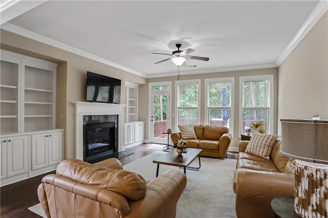 3920 Baverton Dr, Suwanee, GA 30024 - living area featuring ornamental molding, a ceiling fan, a fireplace, wood finished floors, and built in shelves