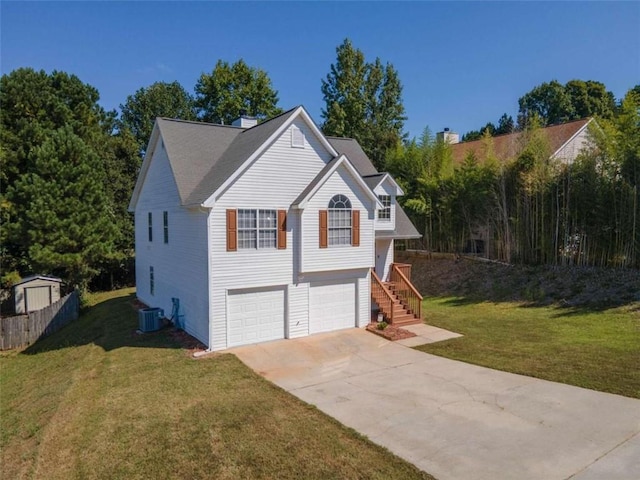 raised ranch featuring a garage and a front yard