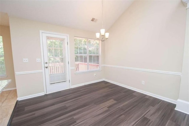 unfurnished dining area with vaulted ceiling, dark hardwood / wood-style flooring, and a notable chandelier