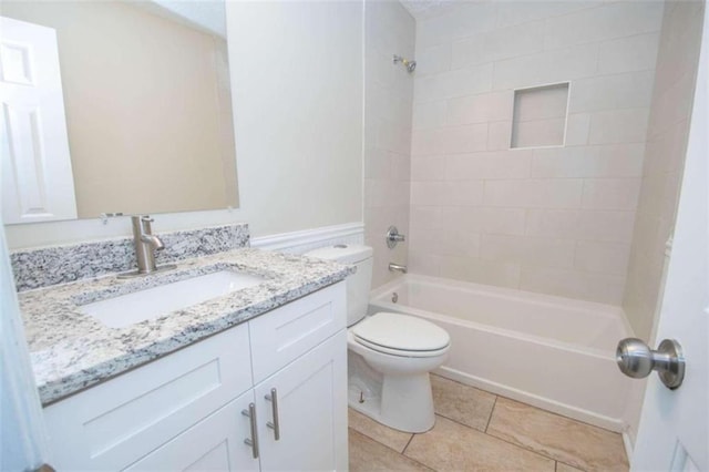 full bathroom featuring tiled shower / bath, vanity, tile patterned flooring, and toilet