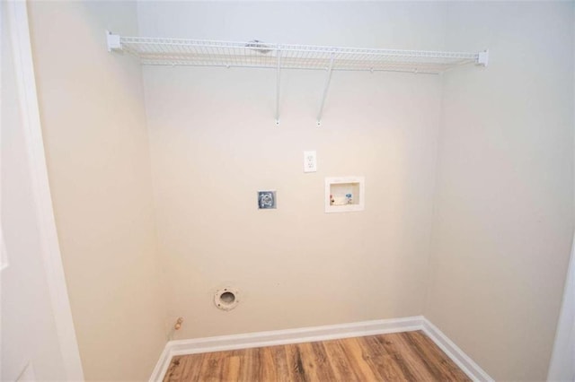 laundry room featuring hookup for an electric dryer, hookup for a gas dryer, hardwood / wood-style flooring, and hookup for a washing machine