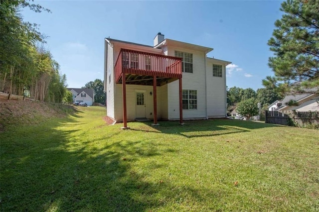 rear view of house featuring a yard