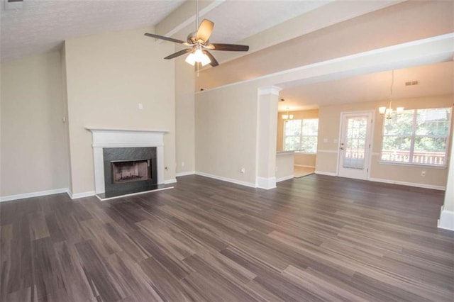 unfurnished living room featuring vaulted ceiling with beams, ceiling fan with notable chandelier, a fireplace, and dark wood-type flooring