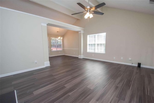 empty room with ceiling fan with notable chandelier, lofted ceiling, and dark wood-type flooring