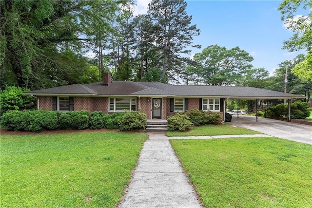 ranch-style house with brick siding, a chimney, a front yard, and concrete driveway