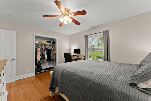 bedroom with light wood-type flooring, a closet, baseboards, and a ceiling fan