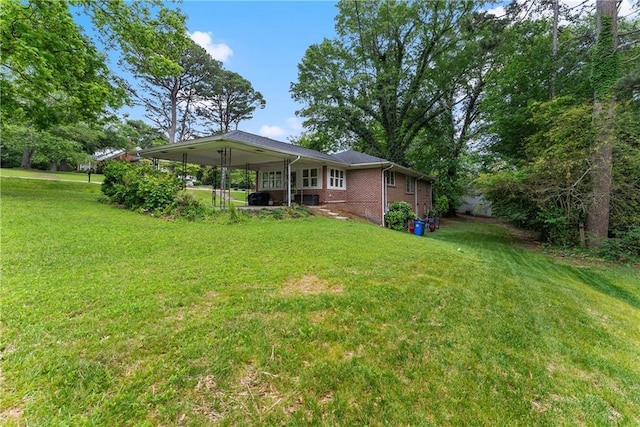 view of green lawn featuring an attached carport