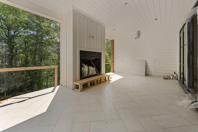 view of patio with a fireplace with raised hearth
