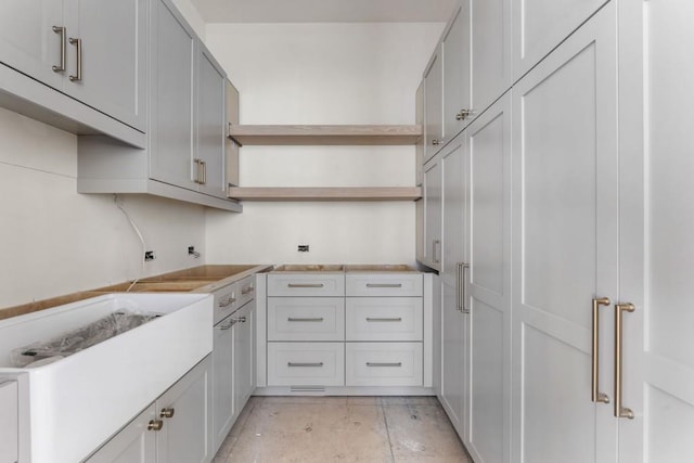 kitchen featuring open shelves and light countertops