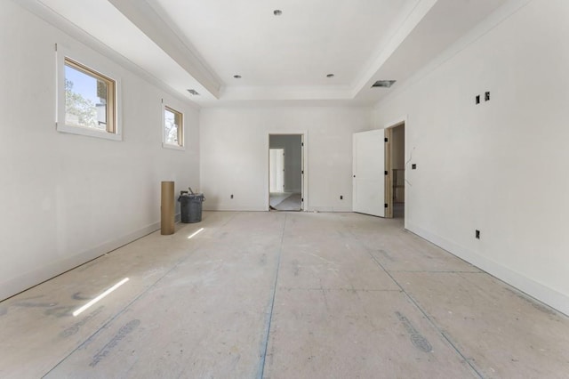 unfurnished room with a raised ceiling