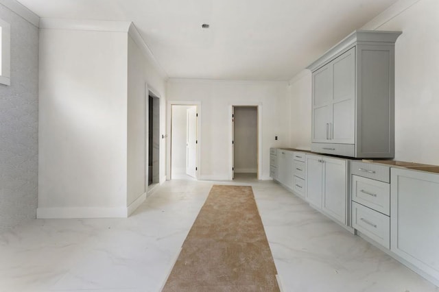 kitchen with gray cabinetry, baseboards, and light marble finish floors