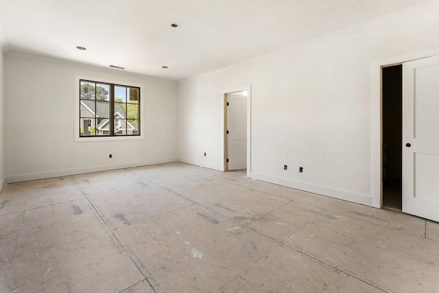 spare room featuring ornamental molding and baseboards