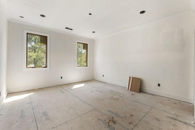 unfurnished room featuring ornamental molding and baseboards