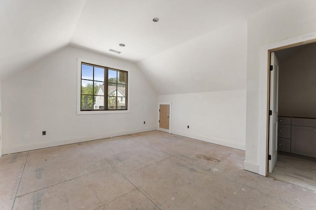 additional living space featuring vaulted ceiling and baseboards