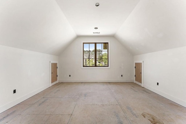 additional living space featuring vaulted ceiling and baseboards