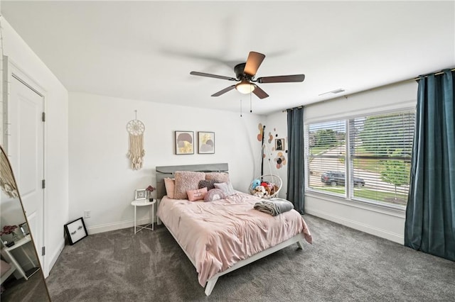 bedroom with dark colored carpet, baseboards, and ceiling fan