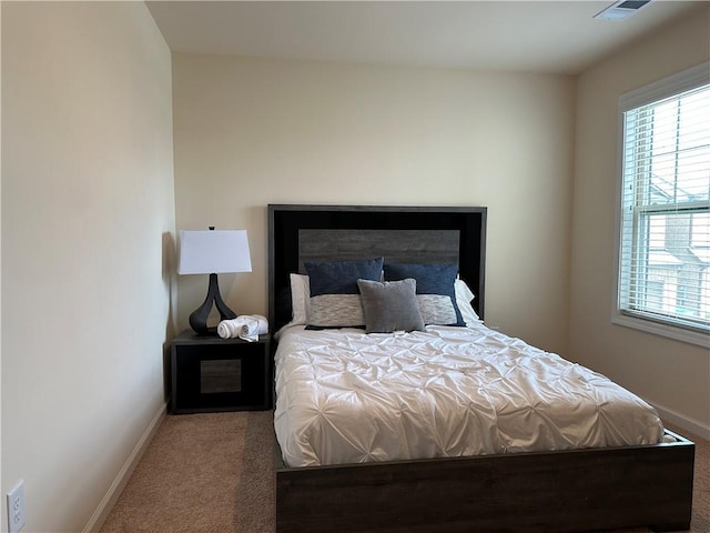 bedroom featuring carpet flooring and multiple windows