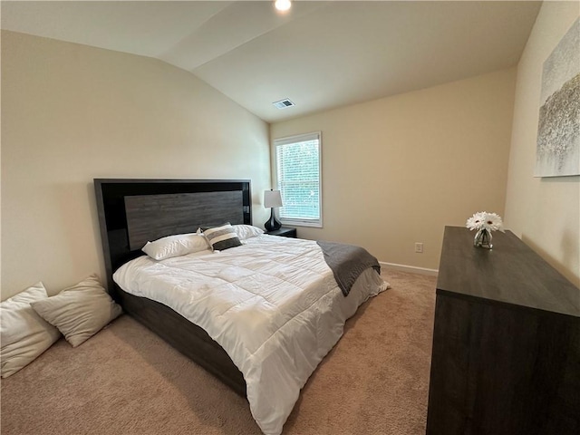 bedroom featuring lofted ceiling and light colored carpet