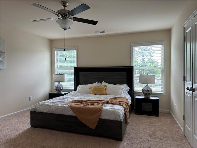 carpeted bedroom with ceiling fan