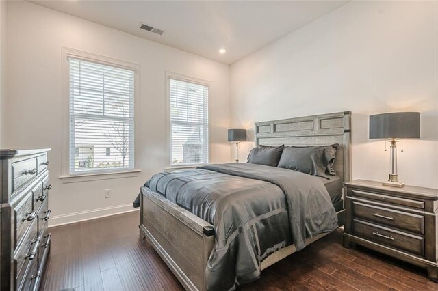 bedroom with visible vents, recessed lighting, dark wood-type flooring, and baseboards