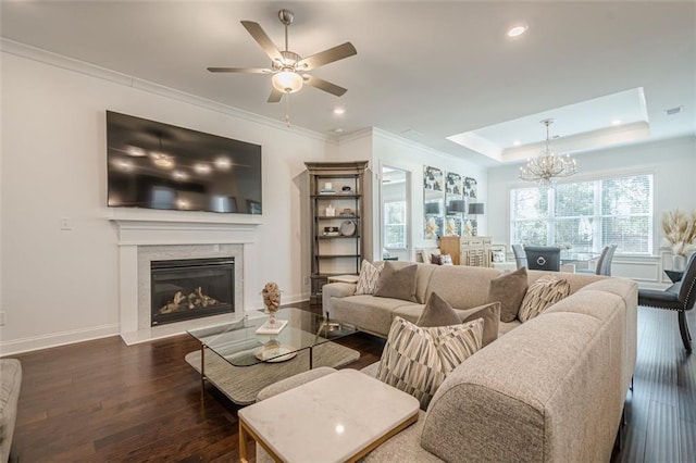 living area with dark wood finished floors, crown molding, and baseboards