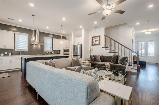living area with visible vents, dark wood finished floors, stairs, recessed lighting, and french doors