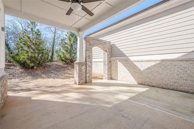 rear view of house featuring central AC, brick siding, ceiling fan, a chimney, and a patio area