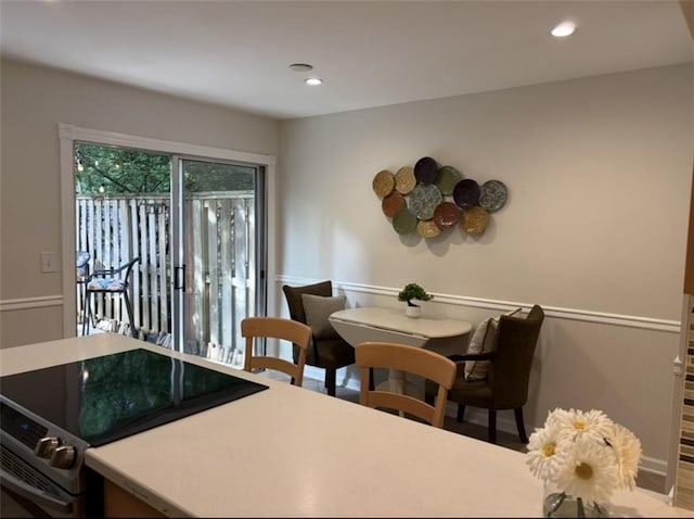 dining area with recessed lighting, wainscoting, and wood finished floors