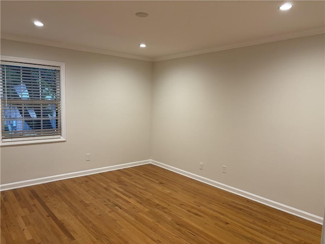 unfurnished room featuring ornamental molding, wood finished floors, recessed lighting, and baseboards