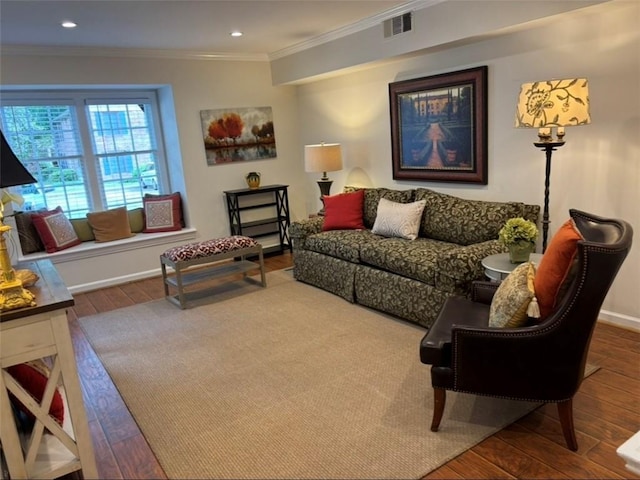 living room with wood finished floors, crown molding, baseboards, and recessed lighting
