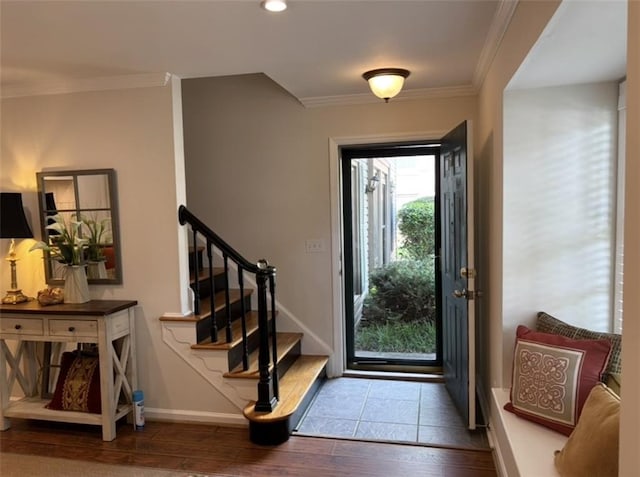 foyer with wood-type flooring, crown molding, stairway, baseboards, and recessed lighting