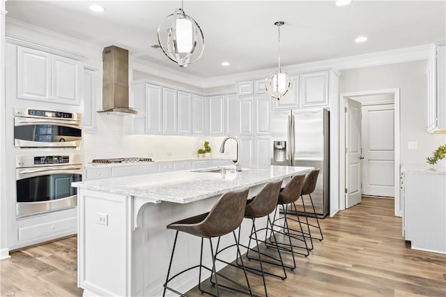 1695 Peyton Farm Dr, Alpharetta, GA 30004 - kitchen with appliances with stainless steel finishes, wall chimney range hood, a sink, white cabinetry, and light wood finished floors