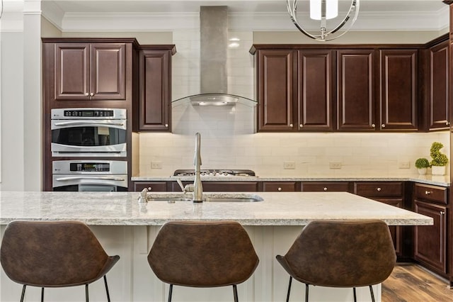 1695 Peyton Farm Dr, Alpharetta, GA 30004 - kitchen with wall chimney exhaust hood, stainless steel double oven, a kitchen bar, light stone counters, and ornamental molding