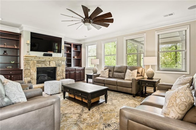 1695 Peyton Farm Dr, Alpharetta, GA 30004 - living room featuring a ceiling fan, ornamental molding, and a stone fireplace
