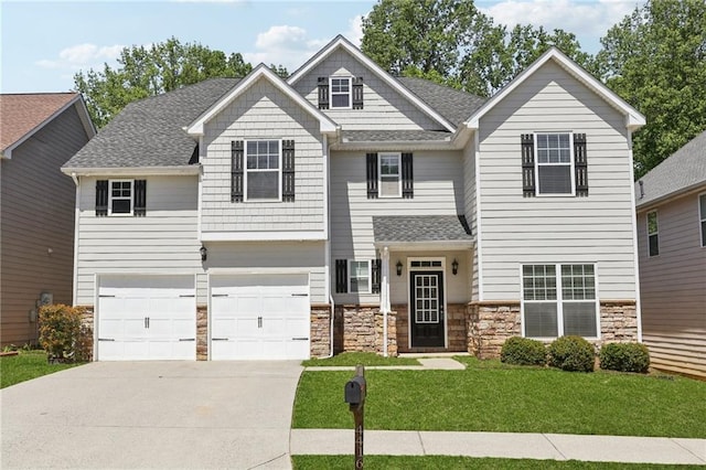 craftsman house featuring a shingled roof, an attached garage, driveway, stone siding, and a front yard