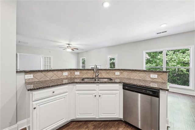 bathroom featuring toilet, a stall shower, baseboards, wood finished floors, and vanity
