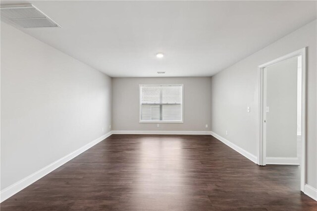 spare room with visible vents, baseboards, recessed lighting, and dark wood-type flooring