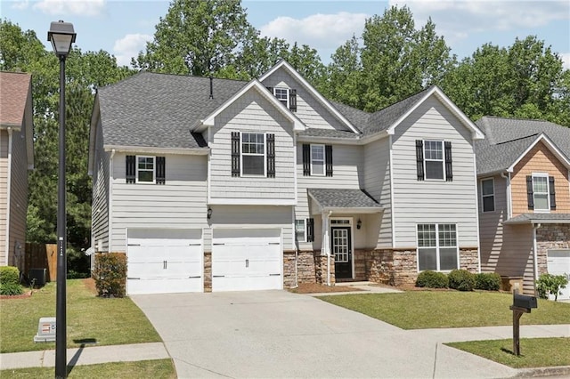 craftsman-style house featuring driveway, stone siding, a shingled roof, an attached garage, and a front yard