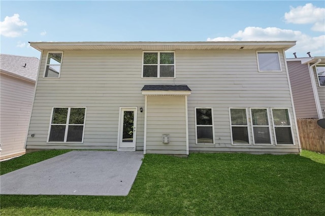 rear view of house featuring a yard, a patio area, and fence