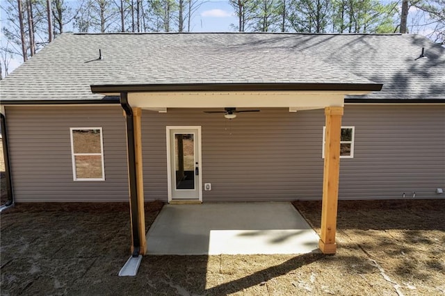 back of property with a shingled roof, ceiling fan, and a patio