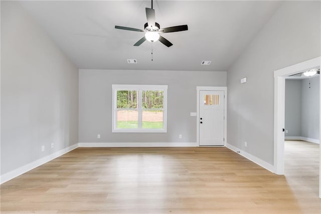 interior space with light wood finished floors, baseboards, visible vents, and a ceiling fan