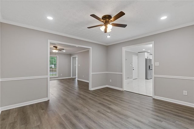 empty room featuring wood finished floors, baseboards, recessed lighting, a textured ceiling, and a ceiling fan